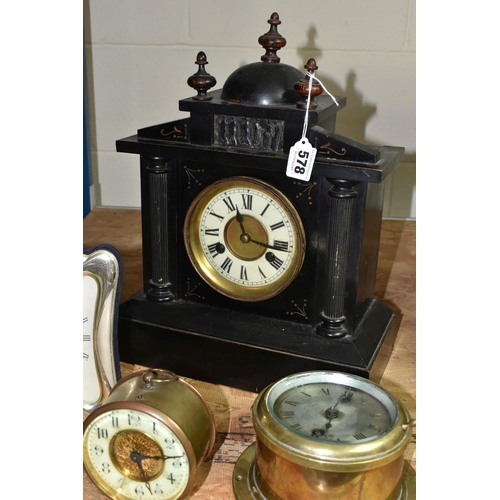 578 - A GROUP OF CLOCKS, comprising a late nineteenth century black wooden cased mantel clock, a brass bin... 