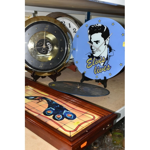 587 - A GROUP OF ELEVEN ELVIS PRESLEY THEMED CLOCKS, comprising seven wall clocks, a circular quartz wall ... 