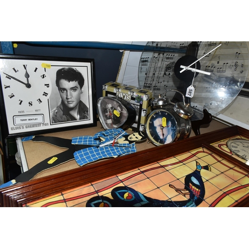 587 - A GROUP OF ELEVEN ELVIS PRESLEY THEMED CLOCKS, comprising seven wall clocks, a circular quartz wall ... 