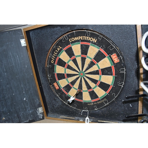 591 - A MY OFFICIAL COMPETITION DART BOARD HOUSED IN A DOUBLE DOOR CABINET, the inside of the doors painte... 