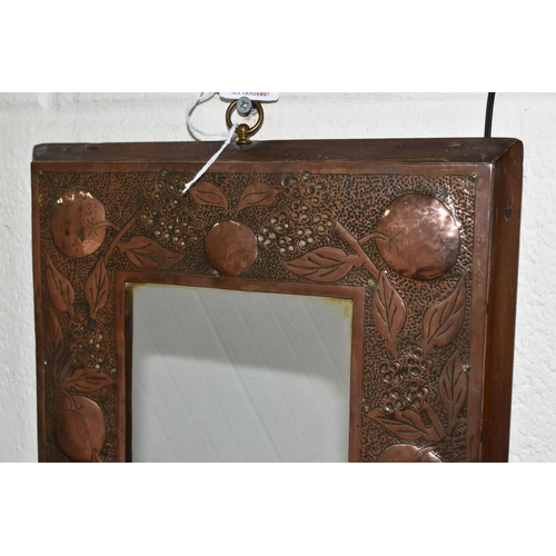 465 - AN ARTS AND CRAFTS STYLE MIRROR, the wooden copper covered frame with hammered design of branches of... 