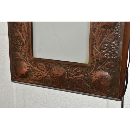 465 - AN ARTS AND CRAFTS STYLE MIRROR, the wooden copper covered frame with hammered design of branches of... 