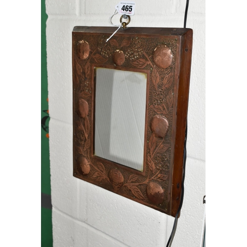 465 - AN ARTS AND CRAFTS STYLE MIRROR, the wooden copper covered frame with hammered design of branches of... 