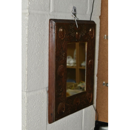 465 - AN ARTS AND CRAFTS STYLE MIRROR, the wooden copper covered frame with hammered design of branches of... 