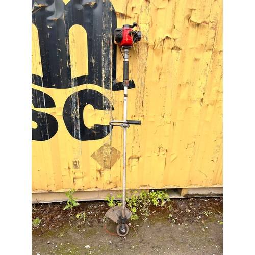 1038 - A KAWASAKI PETROL STRIMMER (condition report: engine turns but not tested any further)