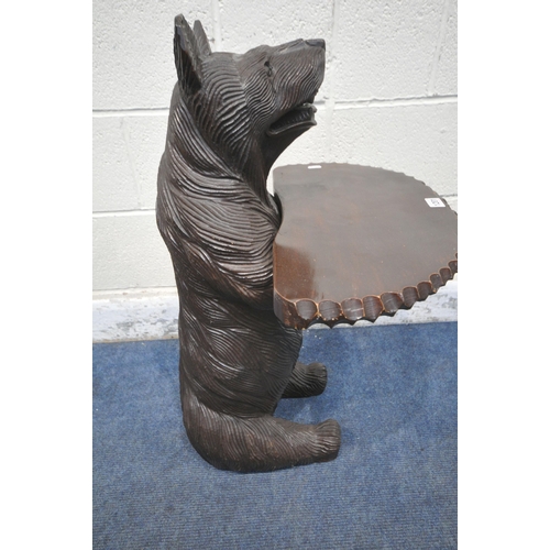 1201 - A REPRODUCTION BLACK FOREST STYLE CARVED WOOD BEAR HOLDING A SHELF, width 49cm x depth 49cm x height... 