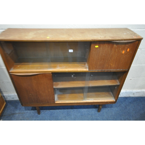 1205 - A MID CENTURY TEAK BOOKCASE, with two pairs of double sliding doors, a fall front door and a cupboar... 