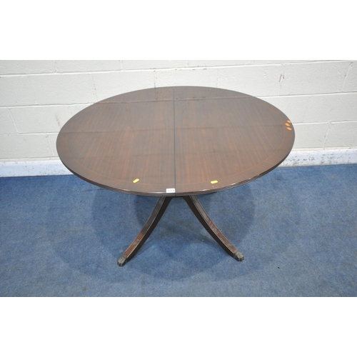 1214 - A 20TH CENTURY MAHOGANY EXTENDING DINING TABLE, with a single fold out leaf, raised on four splayed ... 