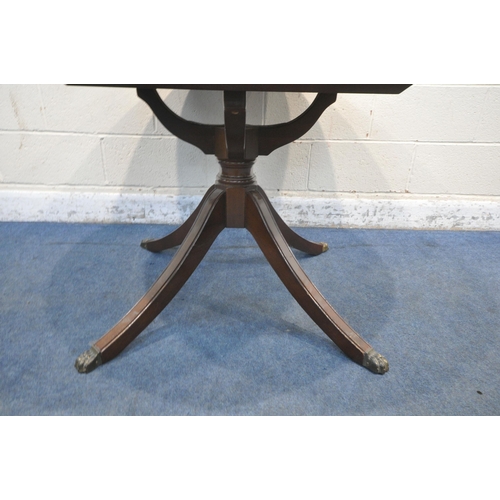 1214 - A 20TH CENTURY MAHOGANY EXTENDING DINING TABLE, with a single fold out leaf, raised on four splayed ... 