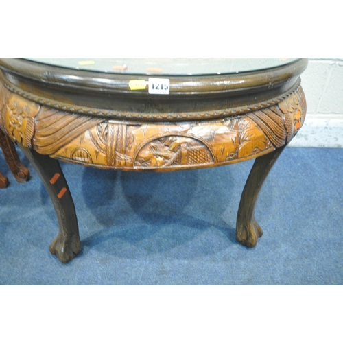 1215 - AN ORIENTAL CIRCULAR COFFEE TABLE, with intricate carved details of birds and trees, raised on four ... 