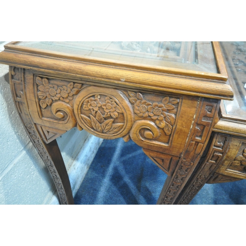 1215 - AN ORIENTAL CIRCULAR COFFEE TABLE, with intricate carved details of birds and trees, raised on four ... 