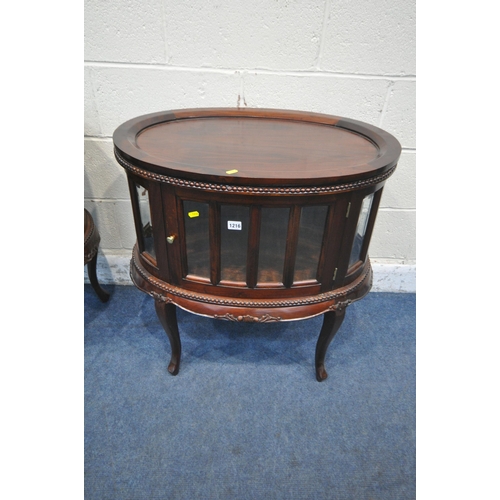 1216 - A REPRODUCTION MAHOGANY OVAL DRINKS CABINET, with a removable tray, bevelled glass panes and a singl... 