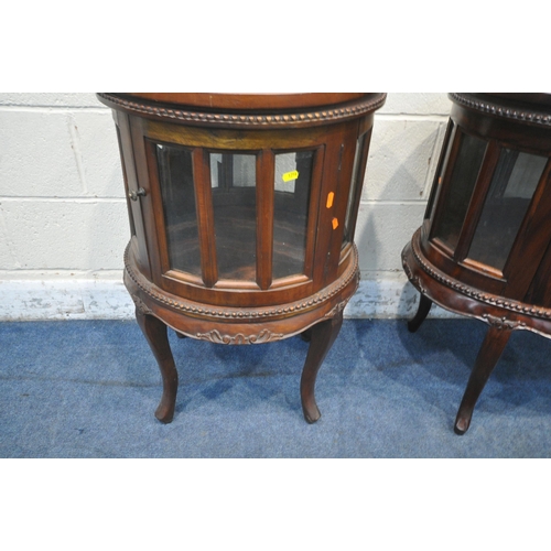 1216 - A REPRODUCTION MAHOGANY OVAL DRINKS CABINET, with a removable tray, bevelled glass panes and a singl... 