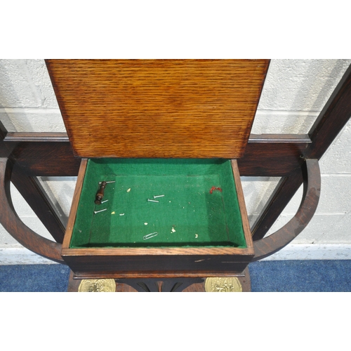 1219 - AN EARLY 20TH CENTURY OAK HALL STAND, with a central rectangular bevelled edge mirror, a hinged stor... 