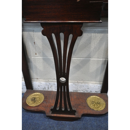 1219 - AN EARLY 20TH CENTURY OAK HALL STAND, with a central rectangular bevelled edge mirror, a hinged stor... 