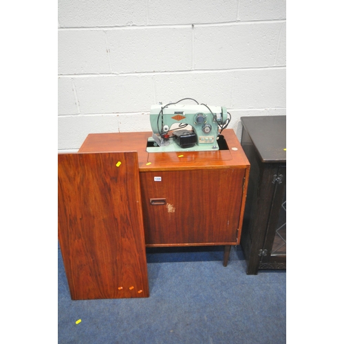 1228 - A MID CENTURY DELTA SEWING MACHINE, with contents, an oak media cabinet, a mahogany media cabinet, a... 