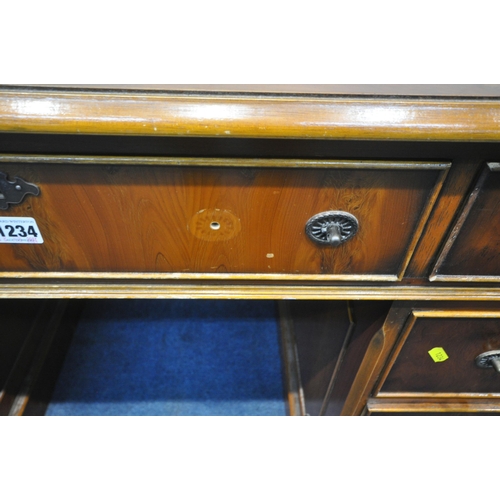 1234 - A REPRODUCTION YEWWOOD TWIN PEDESTAL DESK, with a green leather writing surface, fitted with nine dr... 