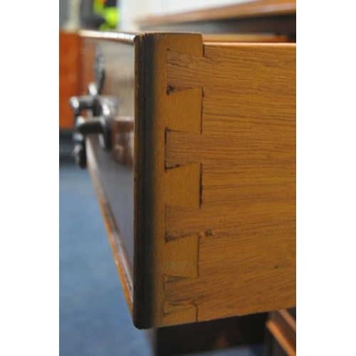 1234 - A REPRODUCTION YEWWOOD TWIN PEDESTAL DESK, with a green leather writing surface, fitted with nine dr... 