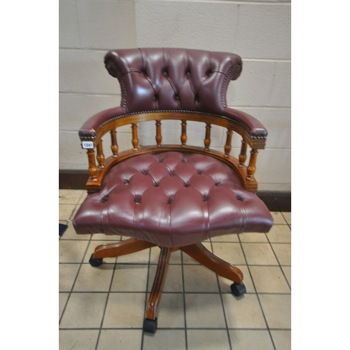 1241 - A BURGUNDY BUTTONED LEATHER SWIVEL OFFICE CHAIR, on casters (condition report: both armrests worn th... 