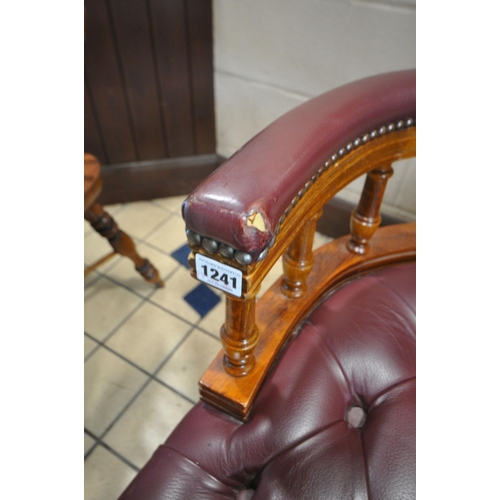 1241 - A BURGUNDY BUTTONED LEATHER SWIVEL OFFICE CHAIR, on casters (condition report: both armrests worn th... 