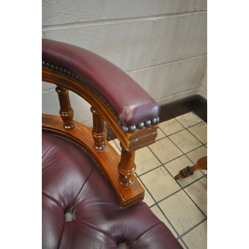 1241 - A BURGUNDY BUTTONED LEATHER SWIVEL OFFICE CHAIR, on casters (condition report: both armrests worn th... 