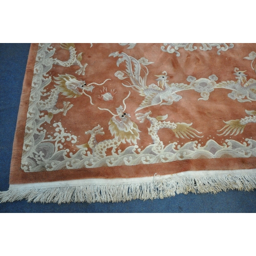 1242 - AN ORANGE WOOLLEN PATTERED CHINESE RUG, 318cm x 250cm (condition report: in need of cleaning, some m... 