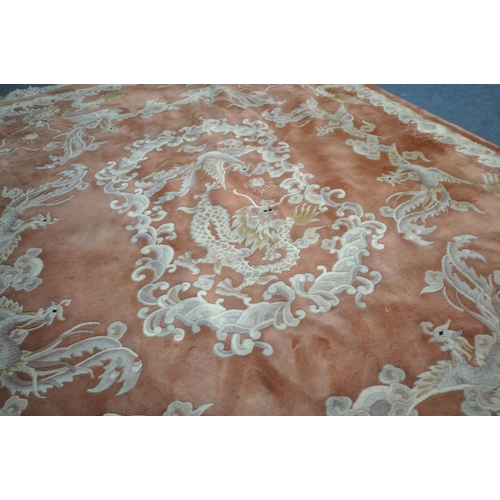 1242 - AN ORANGE WOOLLEN PATTERED CHINESE RUG, 318cm x 250cm (condition report: in need of cleaning, some m... 