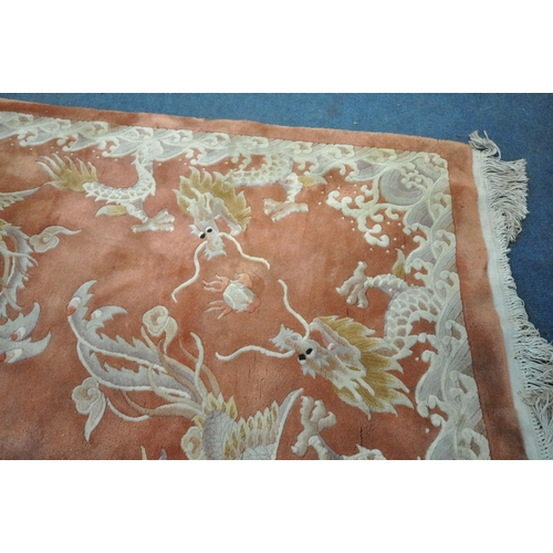 1242 - AN ORANGE WOOLLEN PATTERED CHINESE RUG, 318cm x 250cm (condition report: in need of cleaning, some m... 