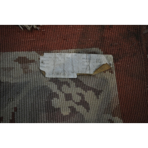 1242 - AN ORANGE WOOLLEN PATTERED CHINESE RUG, 318cm x 250cm (condition report: in need of cleaning, some m... 