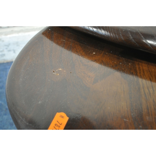 1245 - A MID CENTURY ERCOL DARK ELM PEBBLE NEST OF THREE TABLES, largest table width 66cm x depth 54cm x he... 