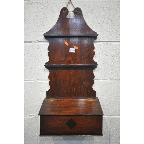 1247 - AN OAK WALL MOUNTED SPOON RACK, in the Georgian style, likely to be late 19th century, with a lidded... 