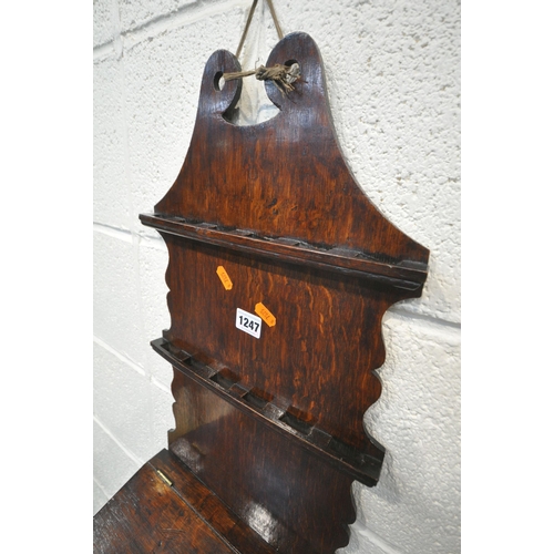 1247 - AN OAK WALL MOUNTED SPOON RACK, in the Georgian style, likely to be late 19th century, with a lidded... 