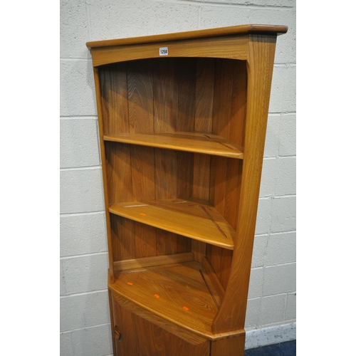 1258 - LUCIAN ERCOLANI, A MID CENTURY ELM AND BEECH WINDSOR CORNER CUPBOARD, fitted with two shelves, above... 