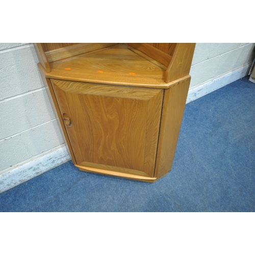 1258 - LUCIAN ERCOLANI, A MID CENTURY ELM AND BEECH WINDSOR CORNER CUPBOARD, fitted with two shelves, above... 