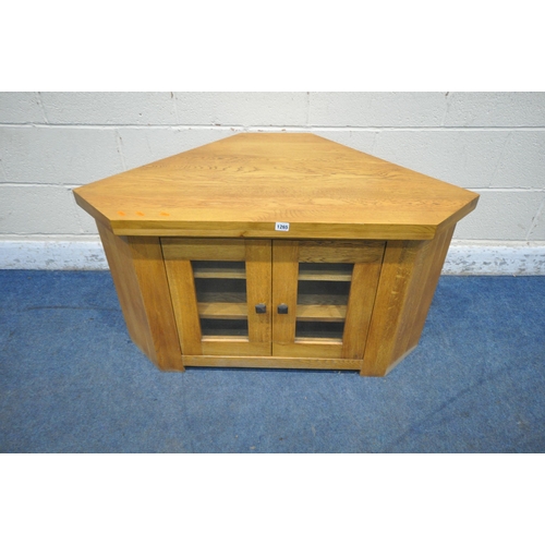 1265 - A SOLID OAK CORNER TV CABINET, with double glazed doors, width 107cm x depth 57cm x height 62cm (con... 