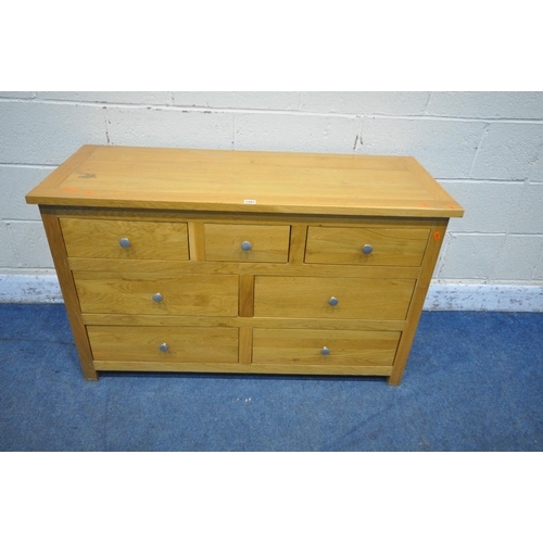 1267 - A SOLID OAK SIDEBOARD, fitted with an arrangement of seven drawers, width 118cm x depth 48cm x heigh... 