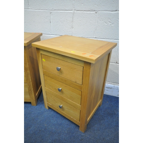 1276 - A PAIR OF SOLID OAK THREE DRAWER BEDSIDE CHESTS (condition report: worn finish to one bedside) (2)