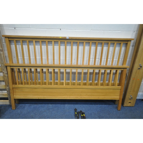 1286 - A SOLID OAK SUPER KING BEDSTEAD, with siderails, slats, and supports (condition report: general sign... 