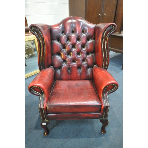 1295 - A BURGUNDY LEATHER CHESTERFIELD WINGBACK ARMCHAIR, on cabriole front legs, width 83cm x seat width 4... 