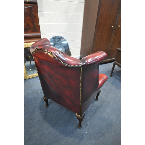 1295 - A BURGUNDY LEATHER CHESTERFIELD WINGBACK ARMCHAIR, on cabriole front legs, width 83cm x seat width 4... 