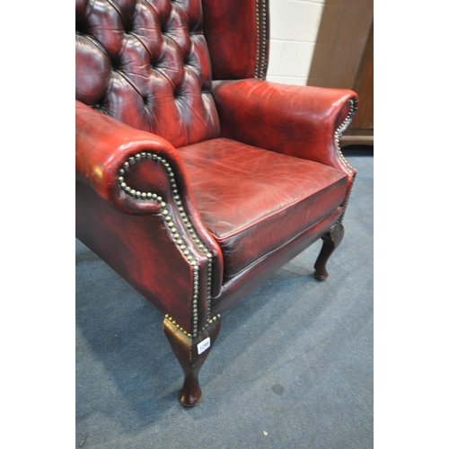 1295 - A BURGUNDY LEATHER CHESTERFIELD WINGBACK ARMCHAIR, on cabriole front legs, width 83cm x seat width 4... 