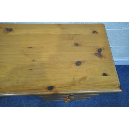 1300 - A MODERN PINE KNEE HOLE DESK, fitted with six drawers, length 143cm x depth 47cm x height 70cm (cond... 