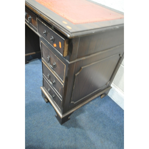 1315 - A 20TH CENTURY MAHOGANY TWIN PEDESTAL DESK, with a red leather writing surface, fitted with an arran... 