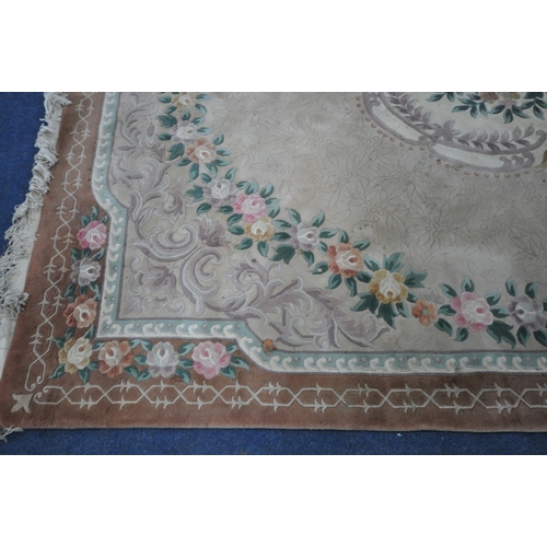 1319 - A LARGE CHINESE WOOLLEN RUG, with a central floral pattern, 374cm x 276cm (condition report: stained... 