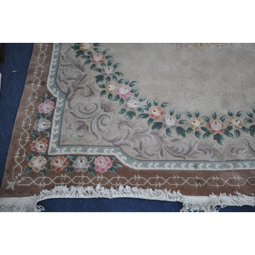 1319 - A LARGE CHINESE WOOLLEN RUG, with a central floral pattern, 374cm x 276cm (condition report: stained... 