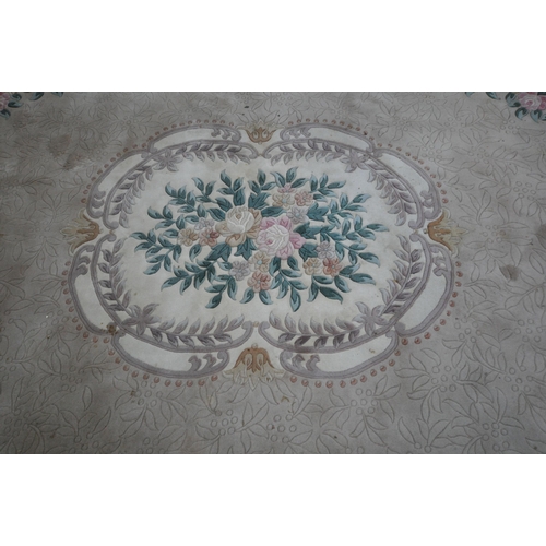 1319 - A LARGE CHINESE WOOLLEN RUG, with a central floral pattern, 374cm x 276cm (condition report: stained... 