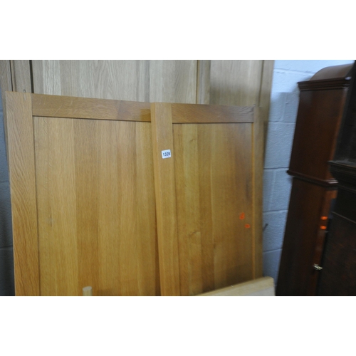 1328 - A SOLID OAK PANELLED DOUBLE DOOR WARDROBE, with a single drawer, width 109cm x depth 60cm x height 1... 