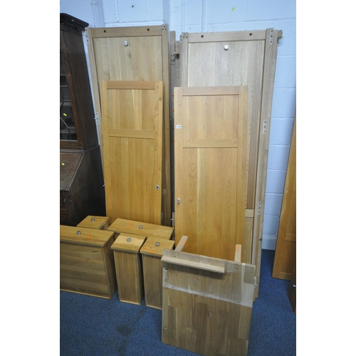 1330 - A SOLID OAK PANELLED WARDROBE, with double panelled doors, flanking a revolving mirror, with an arra... 