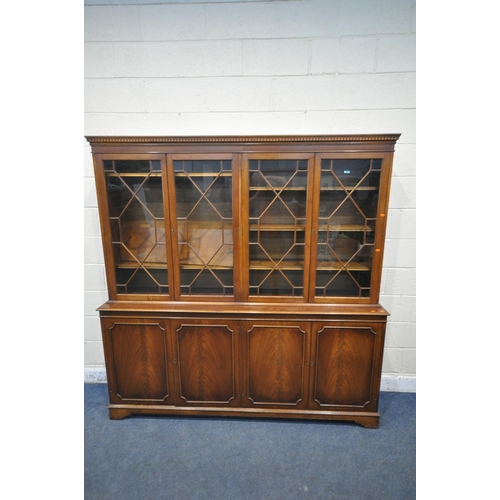 1344 - A LATE 20TH CENTURY MAHOGANY WALL CABINET, with four astragal glazed doors, atop a base with four cu... 