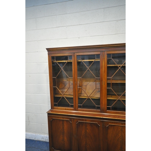 1344 - A LATE 20TH CENTURY MAHOGANY WALL CABINET, with four astragal glazed doors, atop a base with four cu... 